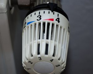 Thermostatic radiator valve on a central heating radiator, set to number 3