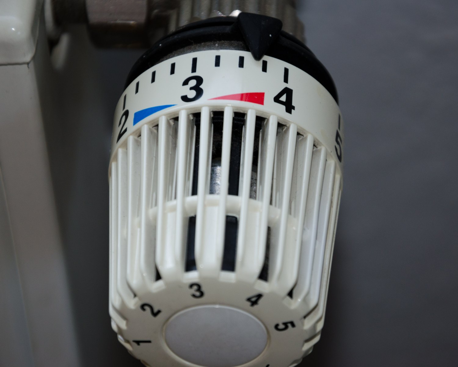 Thermostatic radiator valve on a central heating radiator, set to number 3